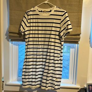 White t-shirt dress with black stripes.